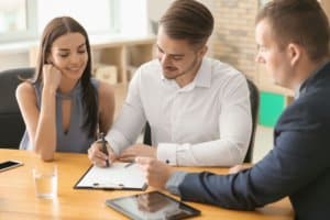 white couple signing mortgage docs